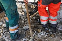 Construction workers digging