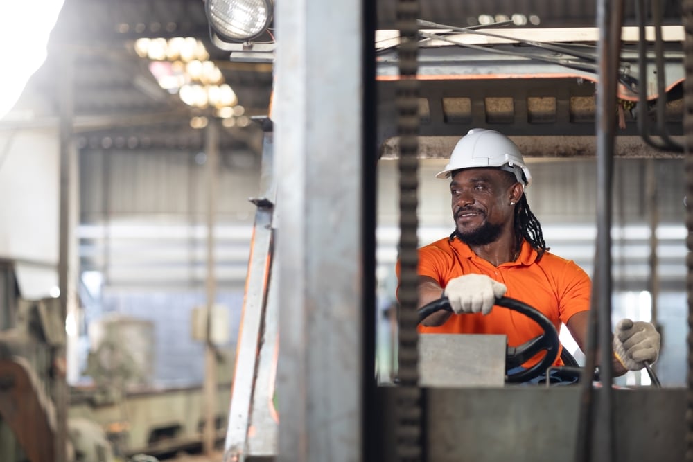 construction worker driving forklift